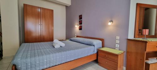 a bedroom with a bed with two pillows on it at 5 Suites Αγιόκαμπος Αγίας in Agiokampos