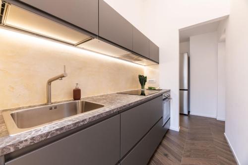 a kitchen with a sink and a counter at Uno - Via Loveno, Menaggio by LoveComo in Menaggio