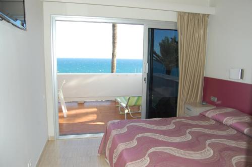 a bedroom with a bed and a view of the ocean at Apartamento Privado en Complejo Aida in Playa del Ingles