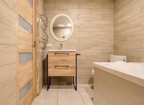 a bathroom with a sink and a mirror at Bebro namai in Vilnius