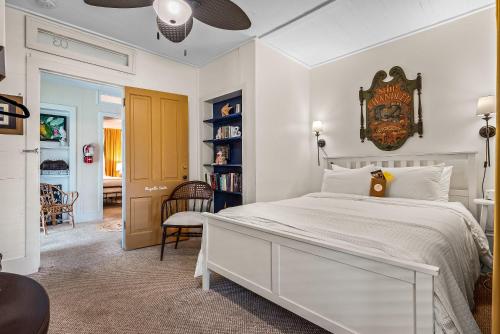 a bedroom with a large bed with a clock on the wall at Old Carrabelle Hotel Regatta Room in Carrabelle