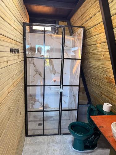 a glass door in a room with a toilet at Alpine Cabin PR 2026 in Tavera Abajo