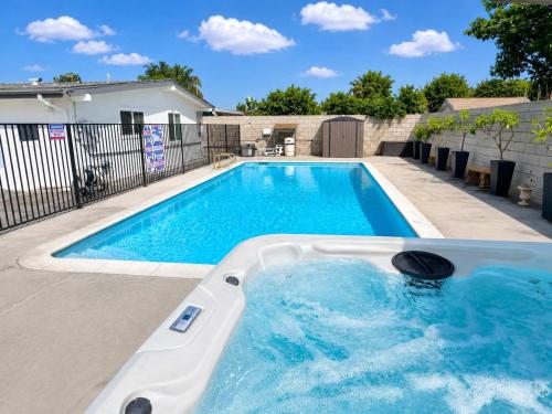 a swimming pool with a hot tub in a backyard at Disneyland Retreat-Pool Spa Game in Anaheim
