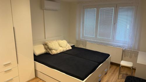 a small bed in a room with a window at Rondel in Žilina