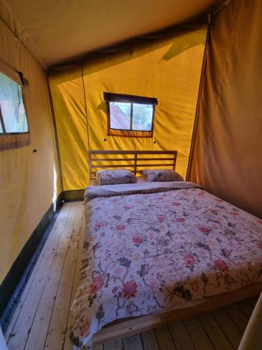 a bedroom with a bed in a tent at Safaritent Aesgestate in Gauw