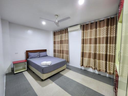 a small bedroom with a bed and a window at 77 Fulaga Flats in Suva