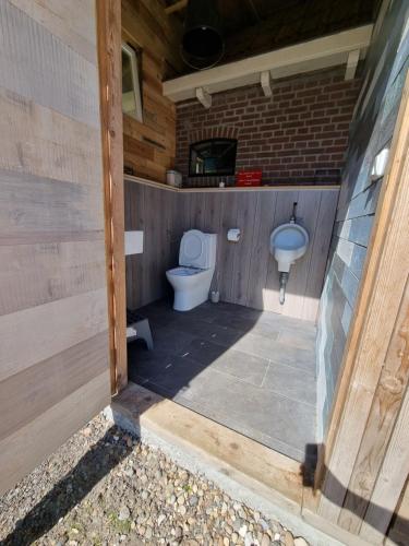 a bathroom with a toilet and a sink at Safaritent Aesgestate in Gauw
