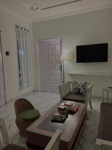 a living room with a couch and a coffee table at Aashiyana retreat in Duimukh
