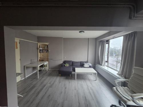 a living room with a couch and a window at The Hague appartment in The Hague