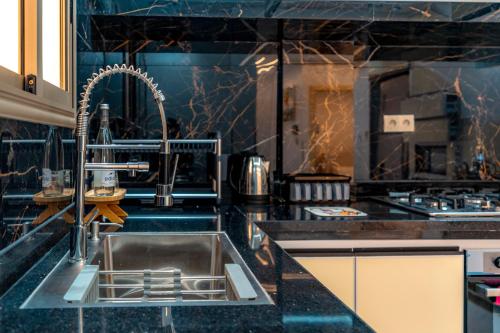 a kitchen with a sink and a stove at Villa America Dakhla in Dakhla