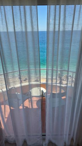 a view of the ocean from a room with a window at Mare Beachfront Rooms Himare in Himare