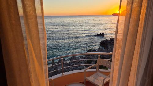 a view of the ocean from a balcony of a ship at Mare Beachfront Rooms Himare in Himare