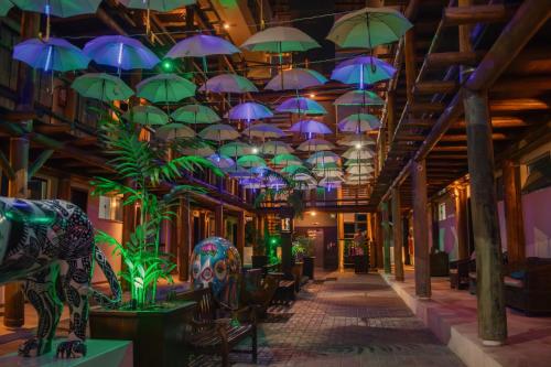 a hallway with umbrellas hanging from a ceiling at Pousada Pedra da Ilha in Penha