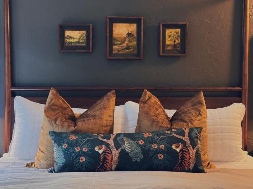 a bed with a bunch of pillows on it at Evergreen Escape in Felton