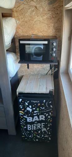 a toaster oven sitting on top of a box at Ardennes Prestige Glamping in La Neuville-aux-Joûtes