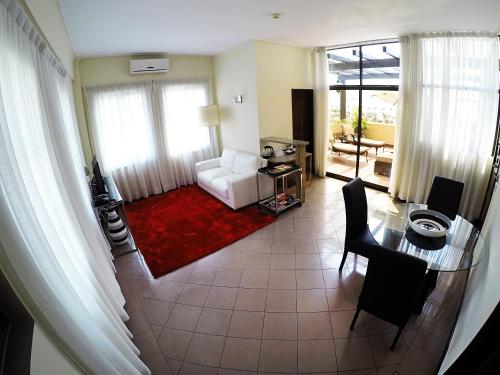 a living room with a white couch and a table at Hotel Continental Luanda in Luanda
