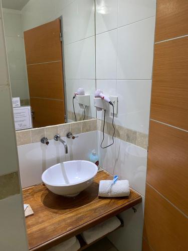 a bathroom with a sink and a mirror at La Mision Posadas in Posadas