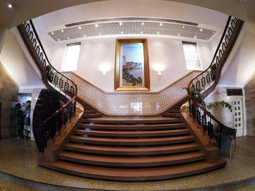 a spiral staircase in a building with a picture on the wall at Hotel Continental Luanda in Luanda
