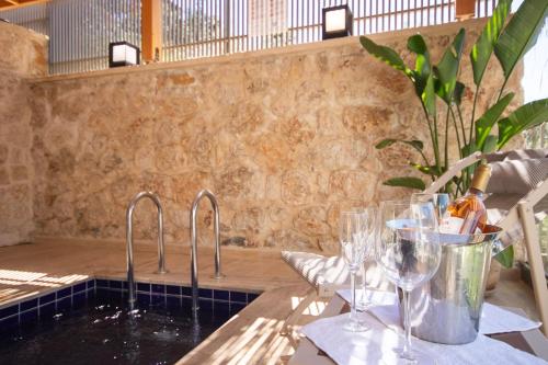 a kitchen with two sinks and wine glasses on a table at Adasya Hotel in Kaş