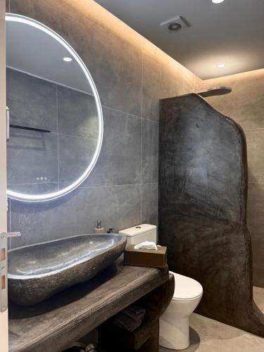 a bathroom with a large tub and a toilet at Lontos Luxury Seaside House in Flampouria