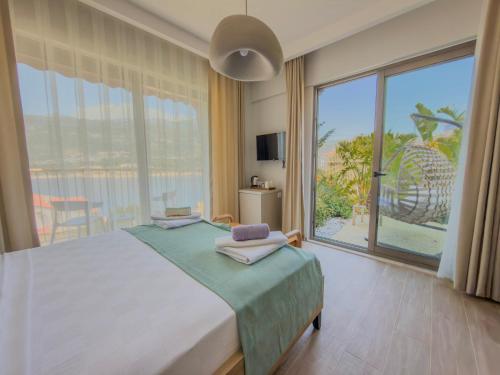 a bedroom with a bed and a large window at Adasya Hotel in Kaş