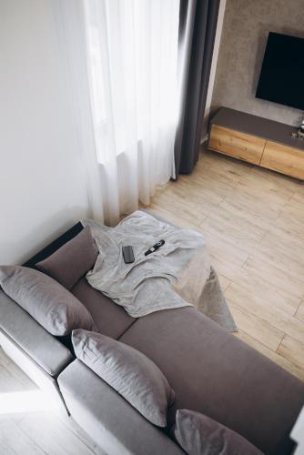 a couch with a tshirt on it in a living room at Apartament Centrum Żywiec - GROJEC in Żywiec