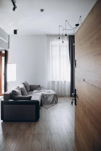 a living room with a couch and a bed at Apartament Centrum Żywiec - GROJEC in Żywiec