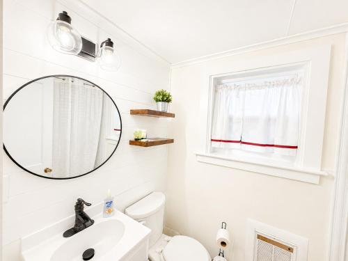 a white bathroom with a sink and a mirror at Cottage 8-9 - Stand Alone 2 Bedroom 2 Bath Private Courtyard Pet Friendly with Fee in Wolfeboro