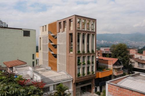 a tall building with windows on a city at BoH Collection in Medellín