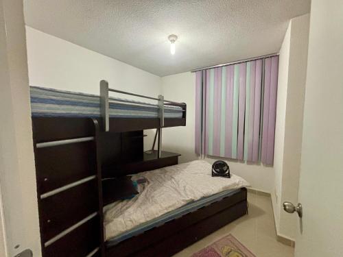 a small bedroom with a bunk bed and a window at Casa Real Santa Fe Cuernavaca in Atlacholoaya