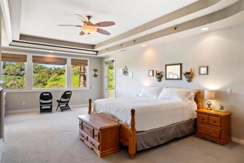 a bedroom with a bed and a ceiling fan at Hilltop Vistas Pool, Wine & Family Fun in Atascadero