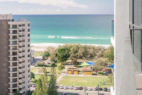 a view of the beach from the balcony of a building at Modern Broadbeach 2BR Apartment - Pet Friendly in Gold Coast