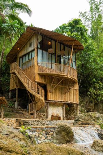 a tree house with a staircase in front of it at Treehouse de Valentine in Balamban