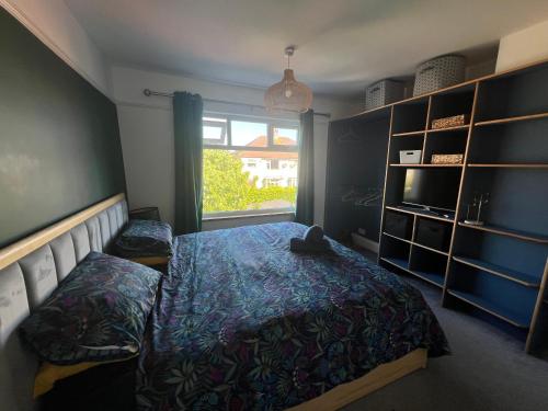 a bedroom with a bed and a large window at Summer Salt house in Morecambe