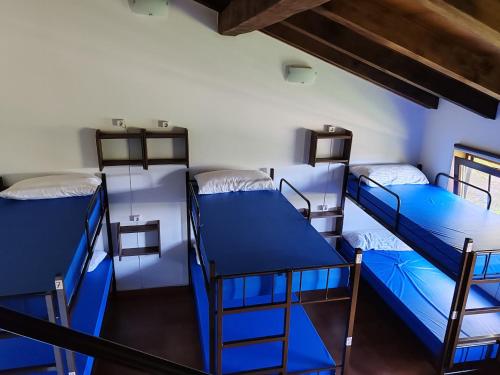 a room with three bunk beds in it at O Solpor Fillobal in Vilar