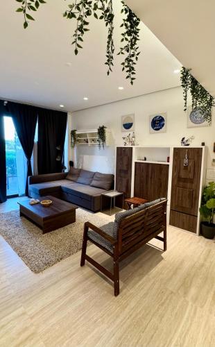 a living room with a couch and a table and a couch at Ayla Oasis Luxury Chalets - Azure & Golf in Aqaba