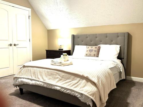 a bedroom with a large bed with a white comforter at The La Grange House in Cleveland
