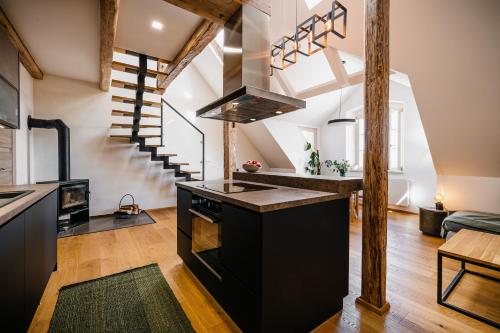 a kitchen with a black island in a loft at Turistka Loft in Kutná Hora
