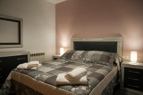 a bedroom with a bed with two pillows on it at Casa Rural La Vereilla in Barajas de Gredos