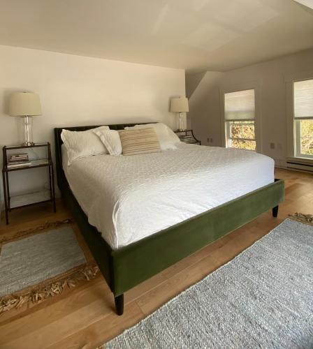 a large bed in a bedroom with two night stands at Sleeping Sailor in Camden