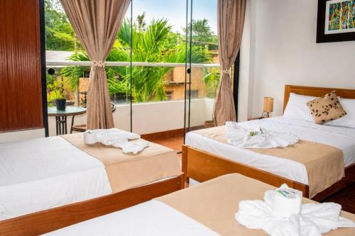 a hotel room with two beds and a balcony at Fanda in Sauce
