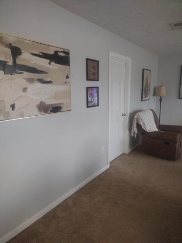 a living room with a couch and a painting on the wall at Lil ranch in White Pine