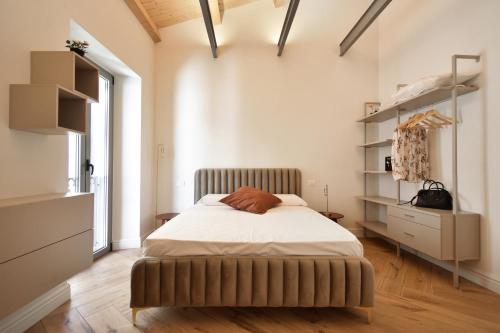 a bedroom with a bed and a dresser in it at B&B Ago e Luce - YourPlace Abruzzo in Vasto