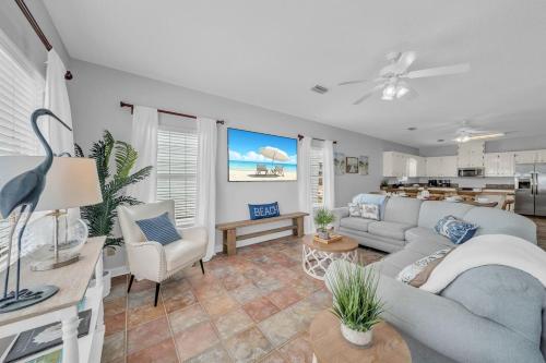 a living room with a couch and chairs and a kitchen at Dandy Sandy Sleeps 24 - Pets - Pools - Hot Tubs in Gulf Shores