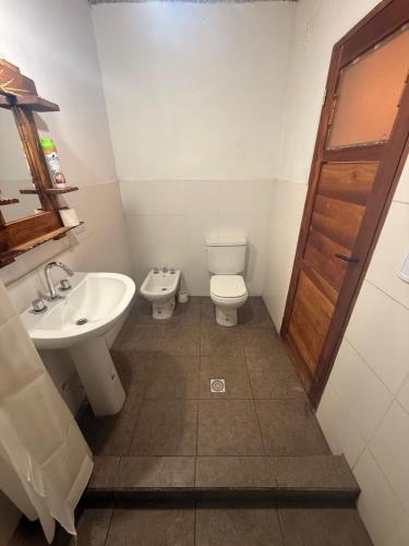 a bathroom with a toilet and a sink at El Rincón de la Quebrada in Tilcara