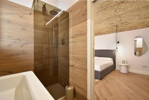 a bathroom with a shower and a bed and a tub at B&B Ago e Luce - YourPlace Abruzzo in Vasto