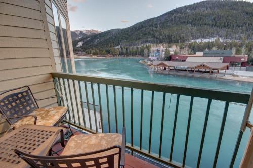 a balcony with chairs and a view of a river at Lakeside 1485 by SummitCove Lodging in Colorado in Keystone