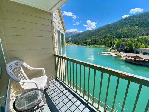 a balcony with a chair and a view of a river at Lakeside 1495 by SummitCove Lodging in Colorado in Keystone
