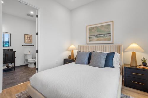 a bedroom with a large bed and a bathroom at OS Hotel in Ocean Springs
