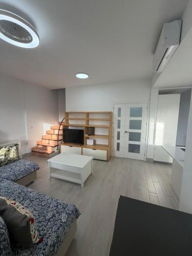 a living room with a couch and a tv at Galia costa ballena 2 in Cádiz